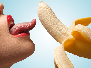 Girl licking a banana